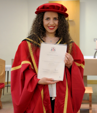 Graduate holding up certificate